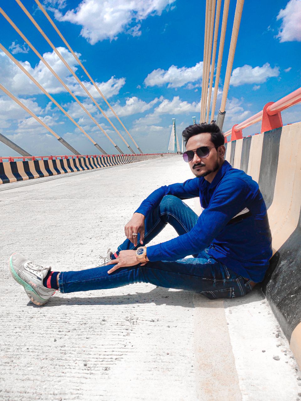 a man sitting on a bridge
